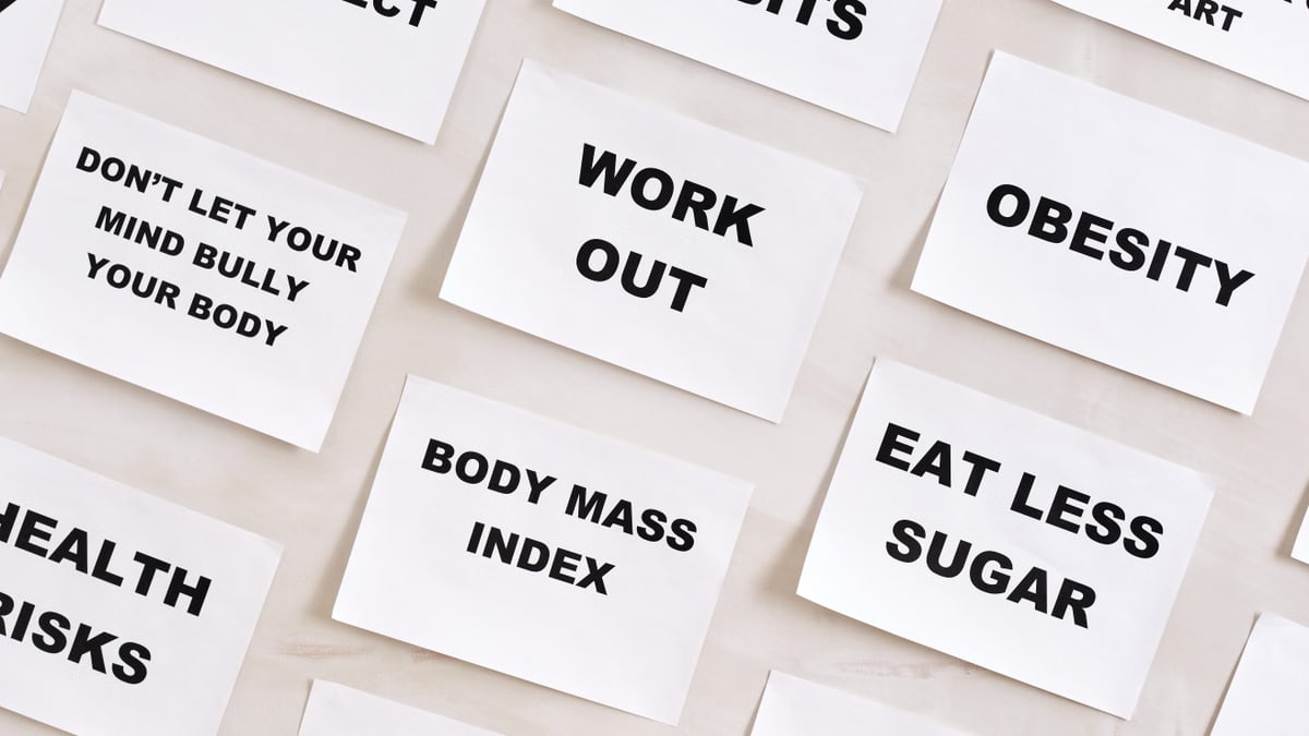 Flat lay of motivational health quotes on paper, promoting healthy habits and self-care.